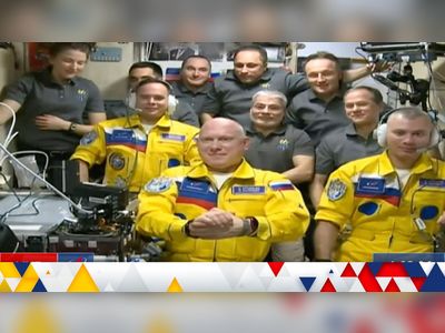 Russian cosmonauts wear Ukrainian colours while boarding International Space Station